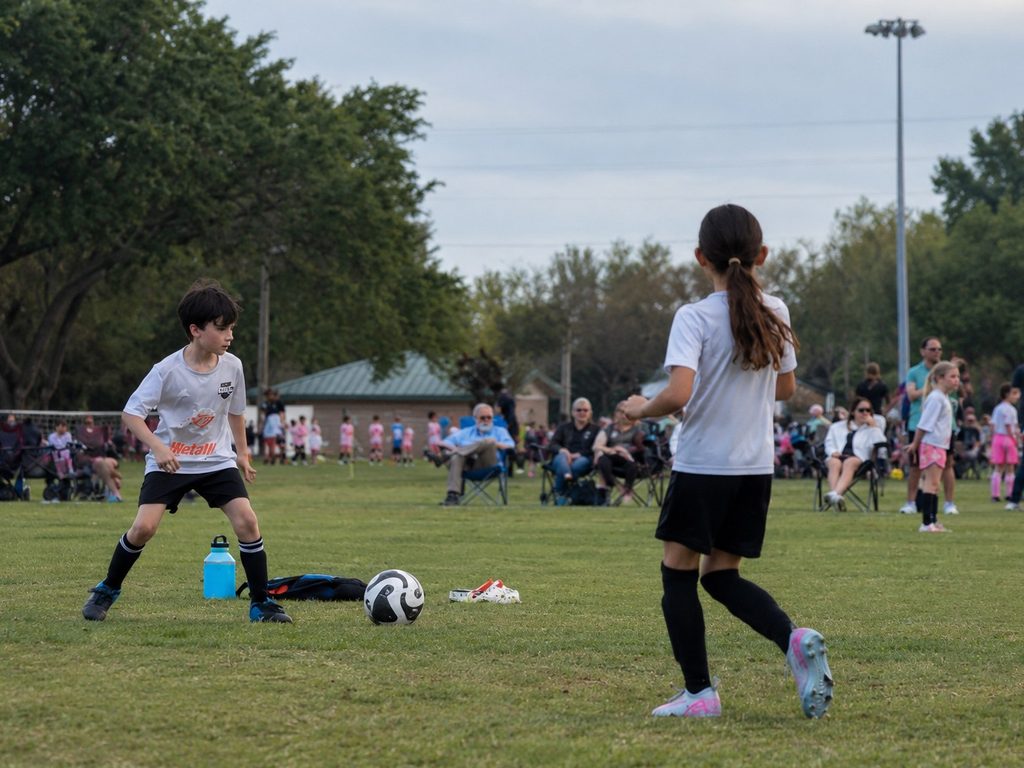 Children playing soccer on a community recreation field